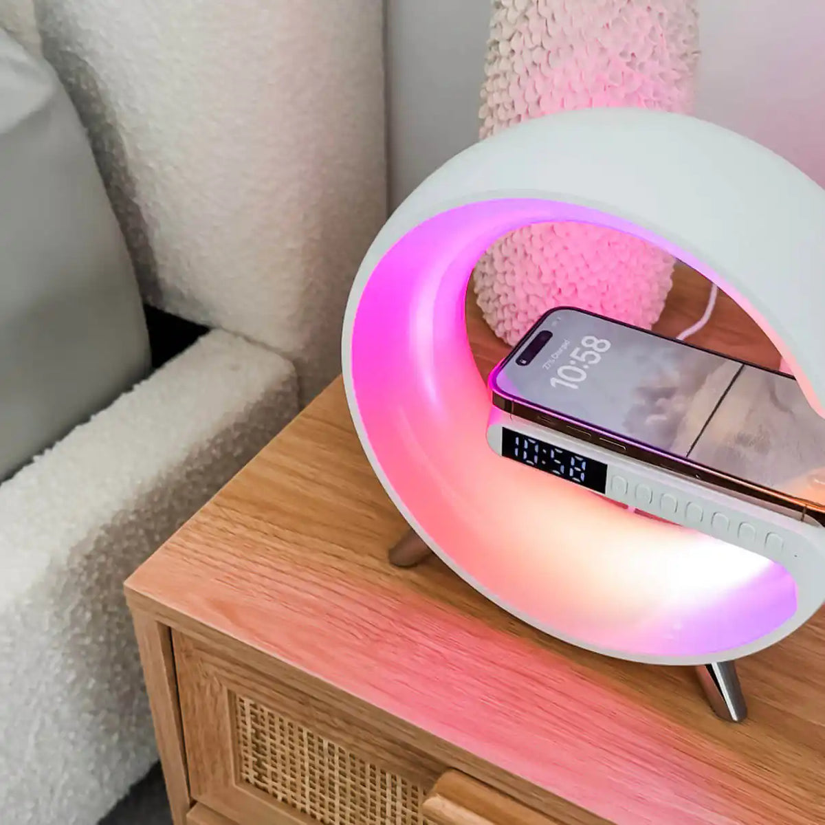 Smart Wireless Charging Alarm Clock charging a phone on a bedside table